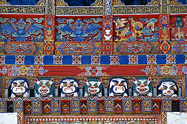 Traditional wood carving and decoration over a doorway at Ugyen Pelri Palace, Bhutan