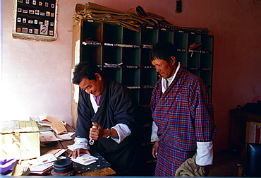 Stamping the post at Paro post office, Bhutan