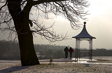 Couple looking at the London skyline at the Observation Point near Kenwood on Hampstead Heath, London