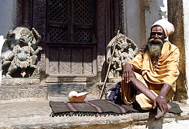 Old man at Swayambhunath Stupa  in Kathmandu valley in Nepal a sacred monument in the Buddhist world