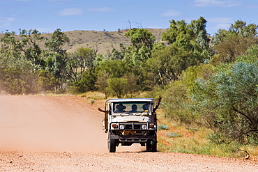 Aborigines in four-wheel-drive vehicle, Mereenie-Watarrka Road, Red Centre, Australia