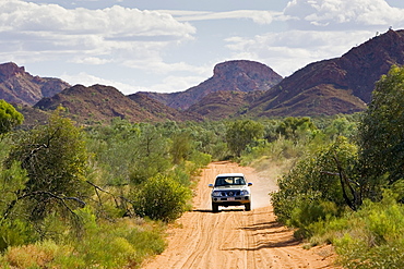 Four-wheel-drive vehicle on the Mereenie-Watarrka Road,  Gosse Bluff, Red Centre, Australia