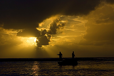 Men fishing at dawn in the Mossman River, Daintree, Australia