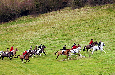 Huntsmen riding across fields during the Heythrop New Year's Day Hunt, Oxfordshire