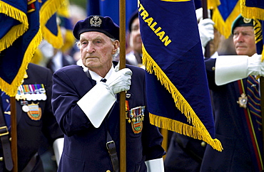 Veterans of the D-Day Landings with their flags in a parade at the start of the 60th Anniversary Commemorations.