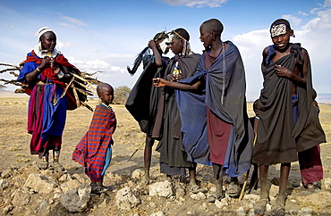 Young recently circumcised Masai Warrior (moran) and a Masai girl with traditional face paint after 'coming of age'  in the Serengei Plains, Tanzania