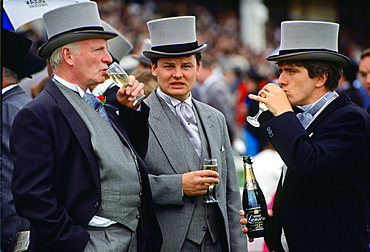 Racegoers drinking champagne at the Epsom Derby, Surrey