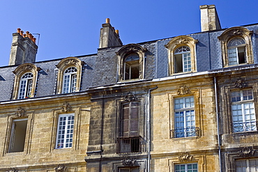 Fire damaged building alongside newly cleaned facades near Place de la Bourse in old Bordeaux