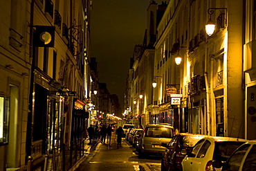 Parisians stroll down Rue Jacob in Paris, France