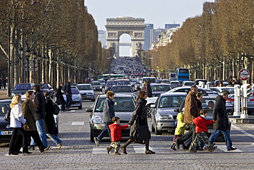 Traffic stops for pedestrians on zebra crossing across Champs-?lys?es in front of the Arc de Triomphe, Central Paris, France