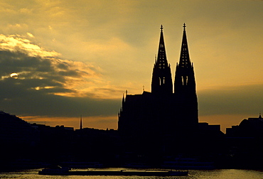 A cathedral in Cologne by the Rhine at sunset, Germany