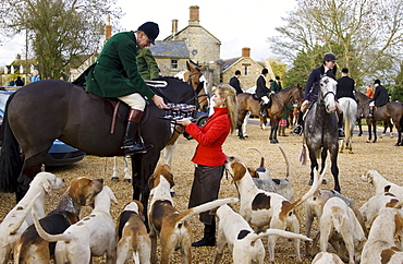 Members of Heythrop Hunt are offered drinks outside the Westcote Inn, Oxfordshire, United Kingdom