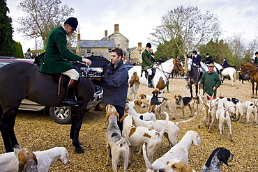 Members of Heythrop Hunt are offered traditional stirrup cup drinks at hunt meet, The Cotswolds, Oxfordshire