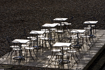 Deserted tables and chairs out of season on Brighton beach, South Coast,  England, United Kingdom