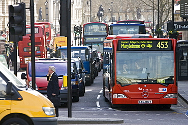 Heavy traffic at a standstill at traffic lights in Trafalgar Square, London city centre, England, United Kingdom