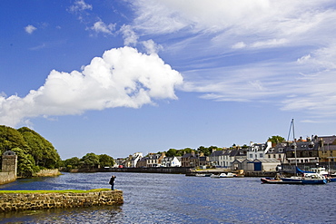 Man looks over at Stornoway harbour, Outer Hebrides, United Kingdom