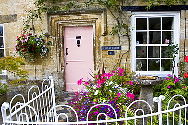 Cotswolds cottage and fenced front garden, Burford, Oxfordshire, UK