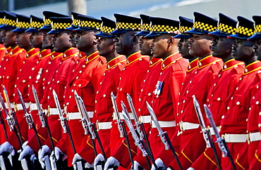 A Guard of Honour, dressed in bright red jackets at Parliament in Kingston, Jamaica