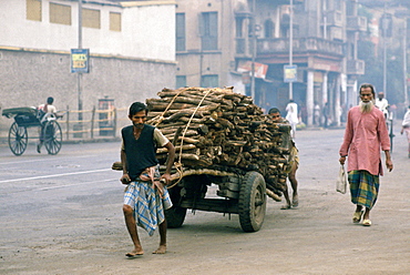 Man transporting wood, Calcutta , India