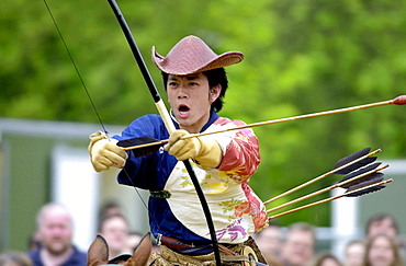 Japanese horseman giving a traditional display of horse riding skills and use of bow and arrows during the exhibition ' matsuri japan in the park ' in hyde park, london.