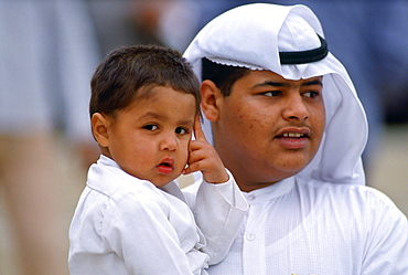 Father carrying his son, Kuwait