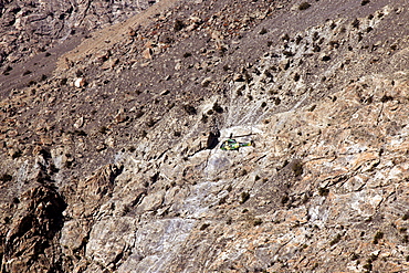 Helicopter flies through valleys of Karokoram Mountains, Skardu Valley, North Pakistan