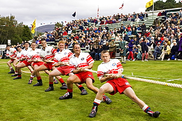 Men compete in Tug O' War contest at the Braemar Games Highland Gathering, Scotland, UK