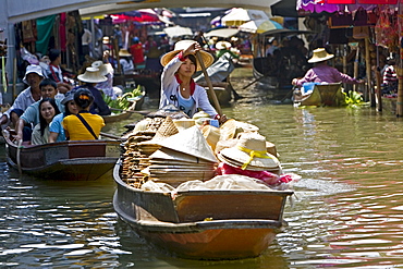 Hat seller in the Damnern Saduak floating market, Bankok, Thailand