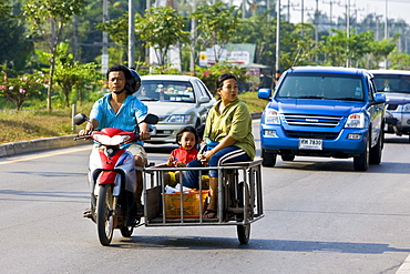 Family travel on a motorcycle and in a side trailer, Bangkok, Thailand