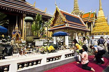 Tourists worship at the Royal Chapel of the Emerald Buddha, Bangkok, Thailand