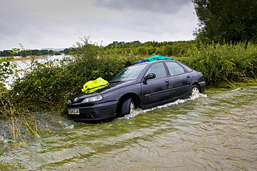 Car forced off the road by flooding in Lyneham, Oxfordshire, England, United Kingdom