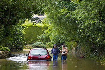 Car abandoned in flood in Ascott-Under-Wychwood, The Cotswolds, Oxfordshire, England, UK