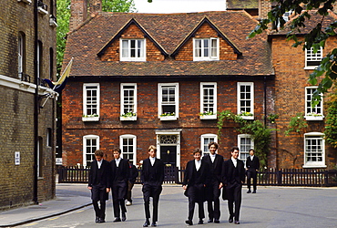 Eton schoolboys in traditional tailcoats at Eton College boarding school, Berkshire, UK.