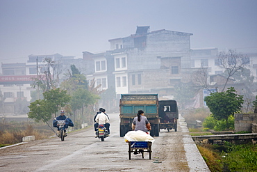 People travelling on the road to Fuli, Xingping, China