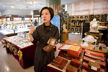 Chinese woman selling Feng Shui compass in gift shop of Shaanxi History Museum, Xian, China