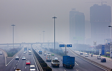 Traffic and pollution on motorway near the financial district of Xian, China