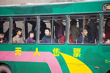 Bus carries workers home in rush hour, Xian city centre, China