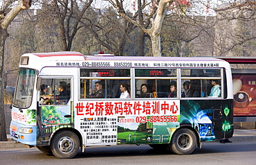 Bus carries workers home in rush hour, Xian city centre, China