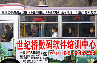 Bus carries workers home in rush hour, Xian city centre, China