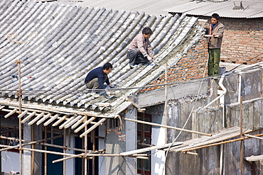 Builders and roofers viewed from The City Wall, Xian, China