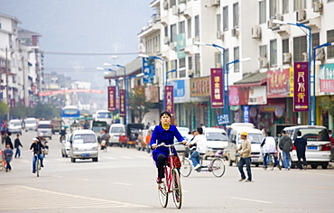 Woman on a bicycle in Yangshuo street, China