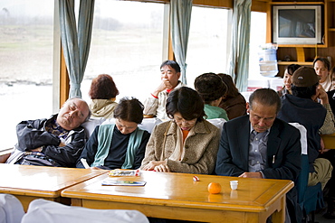 Tourists sleep as they travel by boat along Li River between Guilin and Yangshuo, China