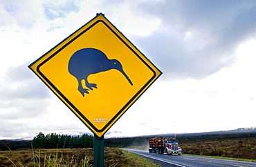 Freight transport truck passes road traffic sign - look out for kiwis, North Island, New Zealand