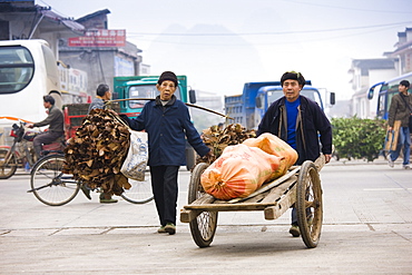 People carry goods to market in Baisha, near Guilin, China