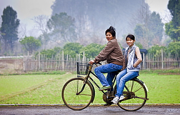 Young people on a bicycle near Guilin, China