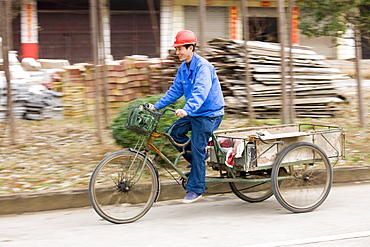 Man with delivery cart on market day near Guilin, China