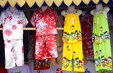 Souvenir stall selling clothing to passing tourists in Fengdu, China