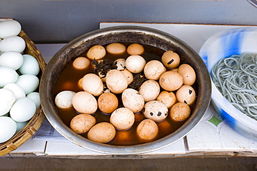 Preserved '1000 year old' eggs (6 months old), on display at food stall in Fengdu, China