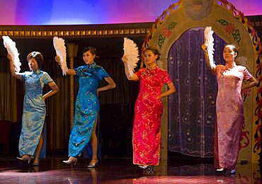 Dancers in cheongsams perform traditional show on Victoria Line Cruise Ship for Western tourists, Yangtze River, China