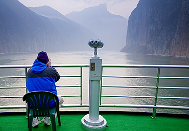 Tourist takes photographs from the deck of Victoria Line Cruise Ship, Yangze River, China